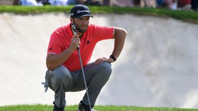 Jon Rahm lines-up a putt. AFP