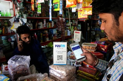 An Indian shopkeeper receives payment by paytm mobile phone technology in Bhopal. EPA