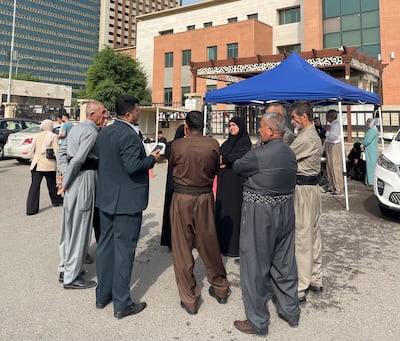Families of victims before the court hearing in Erbil. Aveen Karim/The National