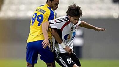 Al Jazira's Rafael Sobis, right, tussles with Al Dhafra's Ali Saeed during their league clash. Despite the win the Jazira boss Abel Braga was reportedly upset with the display.