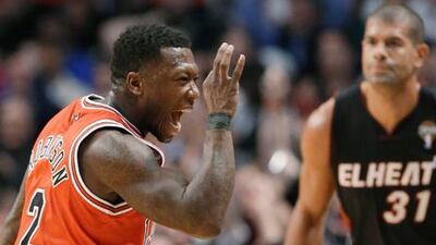 Chicago Bulls guard Nate Robinson celebrates scoring against the Miami Heat to break their winning streak.