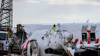 Workers remove the wreckage after investigators has finished their work at the Pegasus Airlines plane that skidded Wednesday off the runway at Istanbul's Sabiha Gokcen Airport, in Istanbul. AP Photo