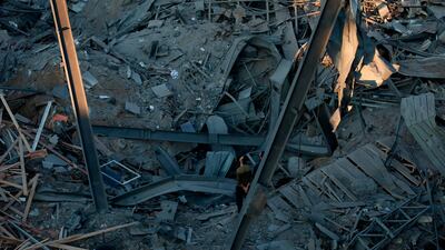Palestinian men check the damage. AFP Photo