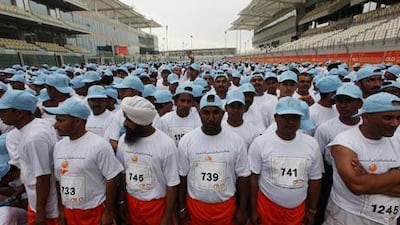 Workers at the start of the 4 kilometre run in celebration of Labor Day and organised by the Ministry of Labor at the Yas Marina track in Abu Dhabi.