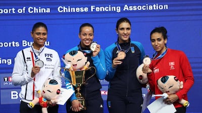 Ines Boubakri of Tunisia, right, poses with silver medalist Ysaora Thibus of France, gold medalist Alice Volpi and bronze medalist Arianna Errigo - both of Italy - at the 2018 World Fencing Championships in China. AFP