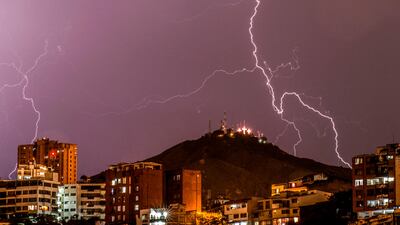 Lightning strikes over the "Cerro de las Tres Cruces" west of Cali, Colombia, during a thunderstorm. Luis Robayo / AFP Photo