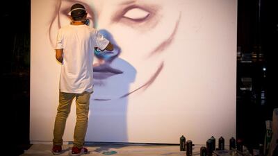 The artist Enforce 1 works on a piece during the launch of Art After Dark. Courtesy Ritz-Carlton, DIFC