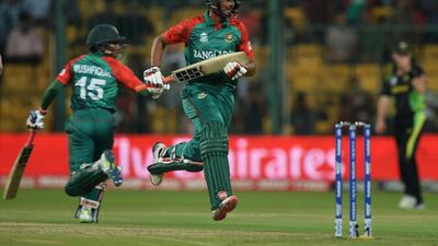 Bangladesh batsman Md Mahmud Ullah, centre, and Mushfiqur Rahim, left, run between wickets during the World T20 match between Australia and Bangladesh at The Chinnaswamy Stadium in Bangalore on March 21, 2016. MANJUNATH KIRAN / AFP