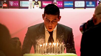 epa06083108 Bayern Munich's new player James Rodriguez blowas out candles on his birthday cake as he is presented during a press conference in Munich, Germany, 12 July 2017. German Bundesliga soccer club Bayern Munich announced on 11 July 2017 James Rodriguez comes from Spain's Real Madrid on a two-year loan. EPA/LUKAS BARTH