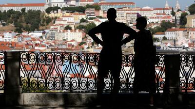 A couple look at Lisbon's skyline from a public garden. Portugal was voted the fourth-best country for expatriates in the survey. AP Photo