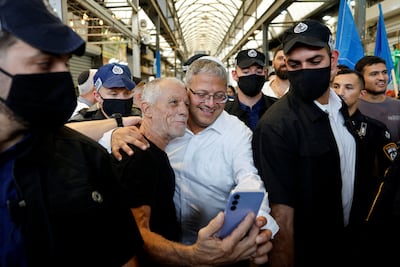 Itamar Ben-Gvir, centre, the Israeli National Security Minister, takes a selfie in public in Ramla, Israel. Reuters