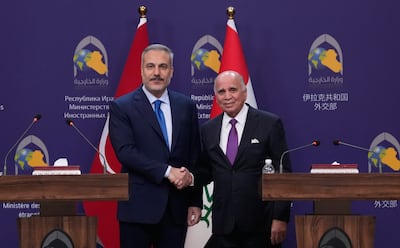 Turkey's Foreign Minister Hakan Fidan, left, visited his Iraqi counterpart Fuad Hussein in Baghdad. AP