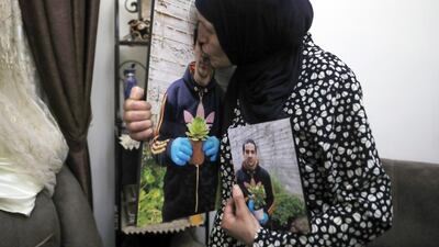 Rana kisses a photo of her son, Eyad Hallaq, in their home in Wadi Joz, a Palestinian neighbourhood in East Jerusalem. AP