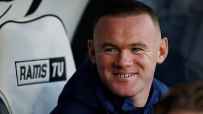 Wayne Rooney watches the Derby v QPR match from the dugout. Reuters