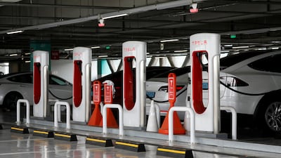 Tesla electric vehicles are charged at a Tesla Supercharger charging station in South Korea. Goldman Sachs forecasts sales of EVs to grow by 32 per cent annually this decade. Reuters