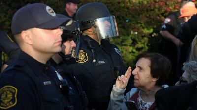 A woman gestures towards a Pittsburgh police officer during a march in memory of the victims of the Tree of Life Synagogue shooting, in Pittsburgh. Reuters