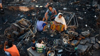 Slum dwellers look for their belongings after a fire broke out in Amritsar, India. AFP