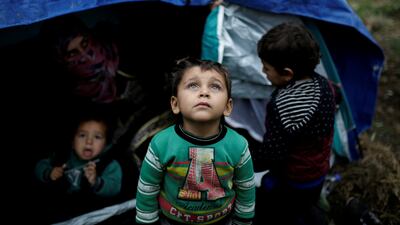 A Syrian refugee boy stands in front of his family tent at the Moria camp on the island of Lesbos, Greece. Reuters