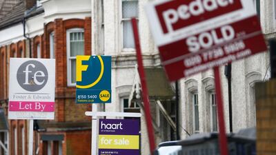 A Foxtons sign among estate agents boards a in south London. The firm has suffered as market slumps. Reuters