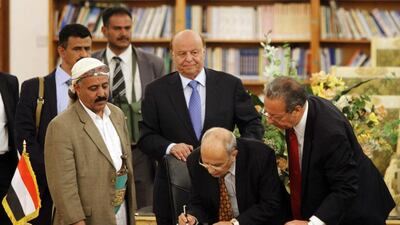 Abd Al Karim Al Iryani (centre, bending) advisor to Yemeni president Abd Rabbu Mansour Hadi (centre, in blue tie) signs the ceasefire agreement to end days of street violence, in the presence of UN special envoy Jamal Benomar (right) in Sanaa September 21, 2014. Yemen's Shiite rebels are calling for a more inclusive government. Mohamed Al Sayaghi/Reuters