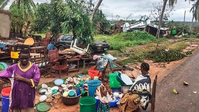 Assane Maulana rescues his belongings with his family in front of his home and shop in Macomia, following Cyclone Kenneth on April 28, 2019. Thousands of people in remote areas of storm-lashed Mozambique were homeless and bracing for imminent flooding April 27, food and water shortages as Cyclone Kenneth flattened entire villages, leaving rescuers struggling to reach them. AFP
