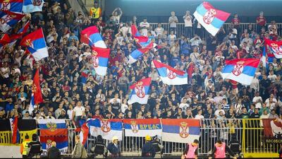 Riot police had to control fans after about a dozen invaded the pitch and players retreated into the tunnel as flares were thrown from the terraces, prompting the suspension of the match. Srdjan Suki / EPA