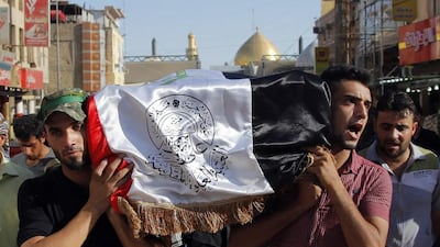 Mourners carry the flag-draped coffin of Abdullah Swadi, a member of an Iraqi volunteer forces group who was killed during clashes with Islamic militants, his family said, during his funeral procession in the Shiite holy city of Najaf on July 8, 2014. Jaber Al Helo / AP