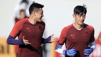 Wang Dalei, left, and Yan Junling during China's training session at Al Wahda Academy in Abu Dhabi.