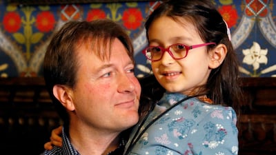 Richard Ratcliffe, the husband of jailed British-Iranian aid worker Nazanin Zaghari-Ratcliffe, sits with his daughter Gabriella during a press conference in London. Reuters