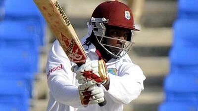 West Indies batsman Chris Gayle put on an unbeaten half-century in the first day against Zimbabwe.