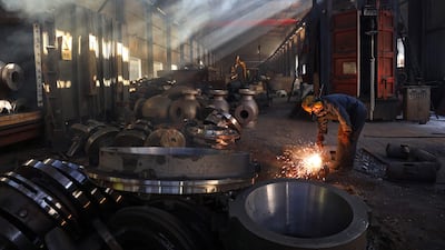 A worker polishes a component at a steel machinery factory in Hangzhou, in eastern China's Zhejiang province. AFP