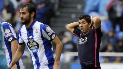 Barcelona’s Luis Suarez, right, reacts after missing a shot. Paulo Duarte / AP Photo