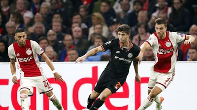 Chelsea midfielder Christian Pulisic weaves between Hakim Ziyech and Joel Veltman. EPA