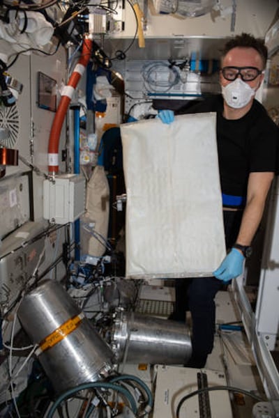 European Space Agency astronaut Matthias Maurer changes out the bladder in the space station’s Brine Processor Assembly. Photo: Nasa