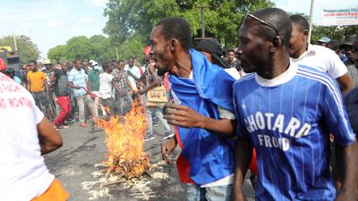 People circle a fire set during a voodoo ceremony during protests demanding that the government of Prime Minister Ariel Henry do more to address gang violence in Haiti. Reuters