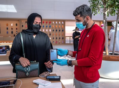 A customer with her new iPhone 13 Pro at the Apple store in Yas Mall, Abu Dhabi. Victor Besa / The National.