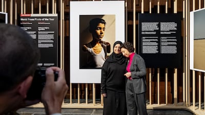 Palestinian photographer Samar Abu Elouf, left, with her winning photo, and executive director of the World Press Photo Foundation Joumana El Zein Khoury. EPA
