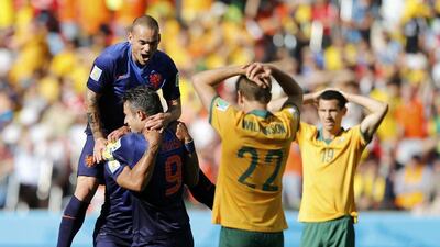 Robin van Persie, front, celebrates asAustralia's Alex Wilkinson, No 22, and Ryan McGowan react on Wednesday at the 2014 World Cup. Edgard Garrido / Reuters
