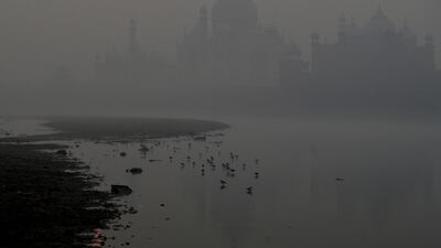 The Taj Mahal is silhouetted in heavy smog as the sun rises in Agra. AFP