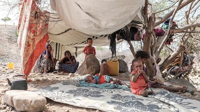Internally displaced people sit in a tent in a makeshift camp in the village of Erebti, Ethiopia. AFP