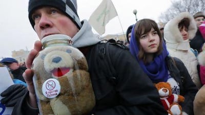 A protester holds a toy inside a glass jar with a sticker reading ‘I'm against Putin’, during a protest rally in St.Petersburg, Russia. About a thousand people gathered in St Petersburg to protest Russia’s new law banning Americans from adopting Russian children.