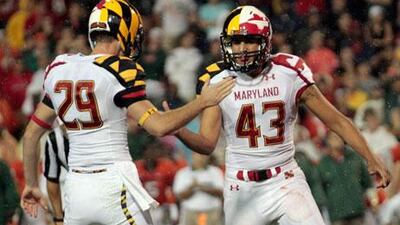 Maryland Terrapins' Michael Tart, No 29, celebrates a late fourth quarter field goal with kicker Nick Ferrara against the Miami Hurricanes at Byrd Stadium in College Park, Maryland, recently.