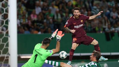 Barcelona's Lionel Messi takes a shot at goal as Sporting's Fabio Coentrao and Sporting goalkeeper Rui Patricio try to stop him. Armando Franca / AP Photo