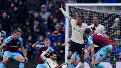 Liverpool's Mohamed Salah, centre right, duels for the ball with Burnley's Ben Mee. AP