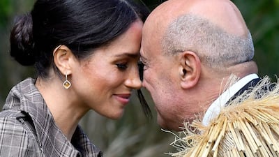 Meghan (L), Britain's Duchess of Sussex, receives a "hongi", or traditional Maori greeting, from an elder during an official welcoming ceremony at Government House in Wellington. AFP