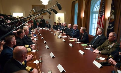 President Donald Trump, fourth from right, speaks in the Cabinet Room of the White House in Washington, on Monday, April 9, 2018, at the start of a meeting with military leaders. Susan Walsh / AP Photo