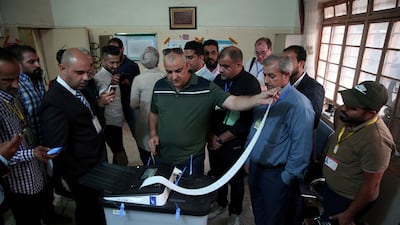 Iraq's Independent High Electoral Commission employee closes a ballot box at a polling station during the parliamentary election in Baghdad, Iraq May 12, 2018. Reuters