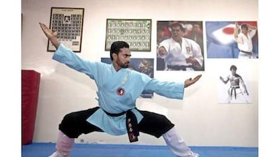 Mujeeb Rahman demonstrates a fighting stance during his class at the Kodokan Martial Arts Club in Ajman.