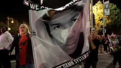 Protesters hold an image of Trayvon Martin while marching in the Leimert Park area of Los Angeles, California, following the George Zimmerman verdict.
