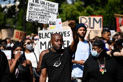 People march as they attend a Black Lives Matter protest in London, Sunday, July 12, 2020, after the killing of George Floyd by police officers in Minneapolis, US, last month. AP